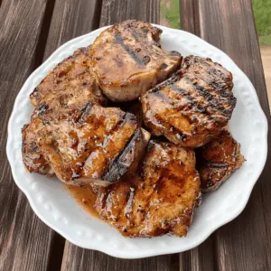 Fire up your grill for these juicy grilled pork chops topped with a zesty peach glaze! Infused with a delightful sweet and spicy flavor, this recipe is perfect for summer barbecues or a cozy dinner. Don't forget to save this pin and impress your friends at your next gathering! 🍑🔥