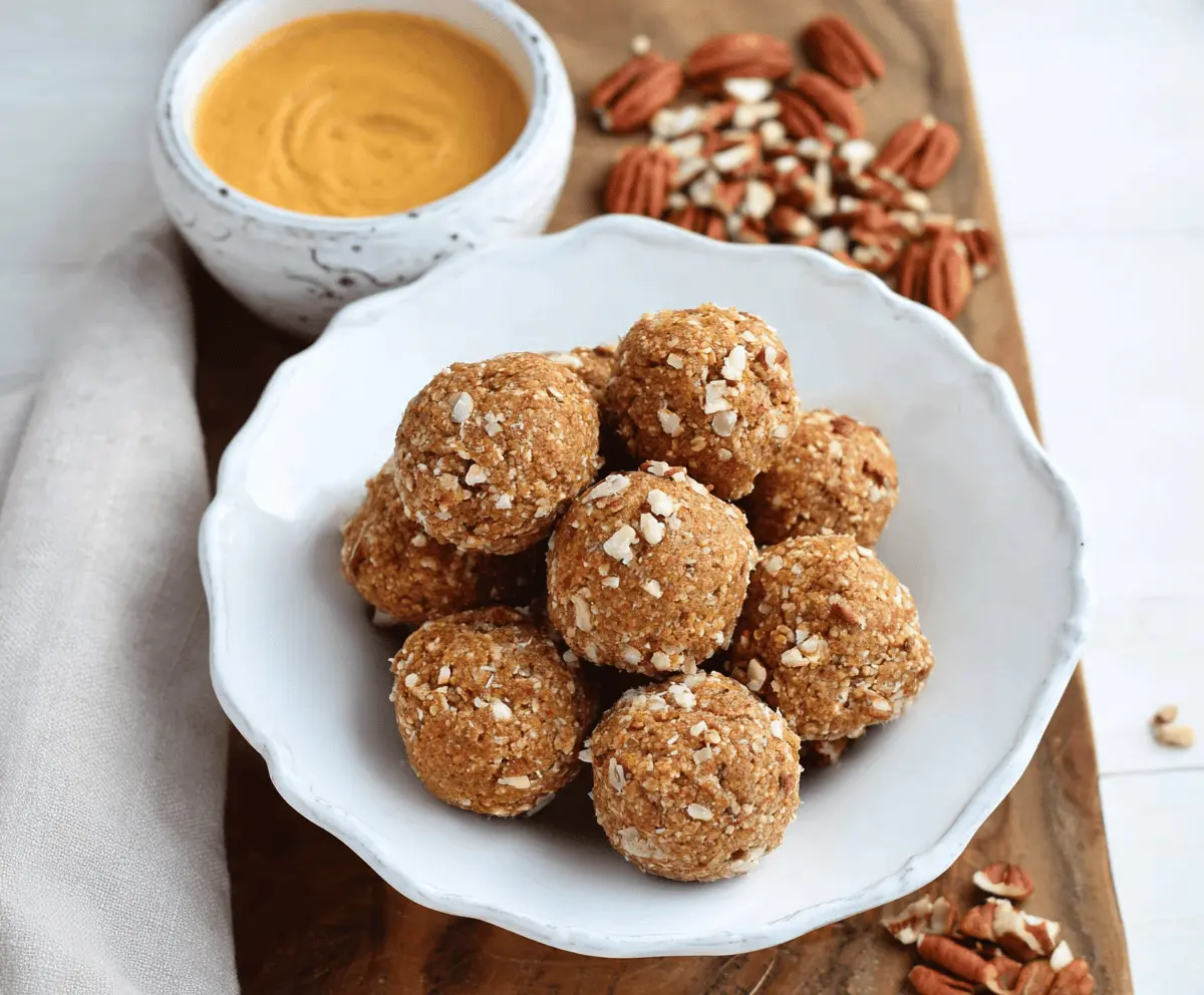 Delicious Maple Pecan Pumpkin Protein Balls on a white plate with fall-themed decorations, perfect healthy snack or energy bites