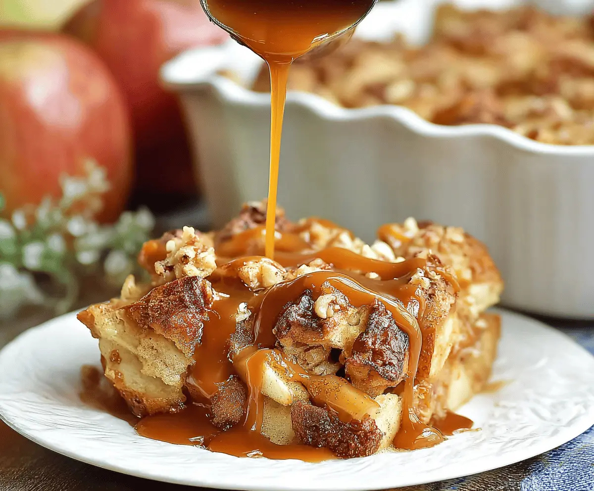 Delicious caramel apple bread pudding topped with caramel sauce and fresh apple slices, perfect for fall dessert.