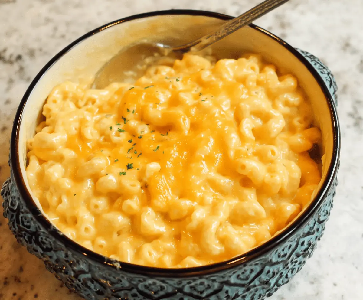 Creamy Paula Deen's Mac and Cheese with golden-brown cheese crust, served in a rustic bowl.
