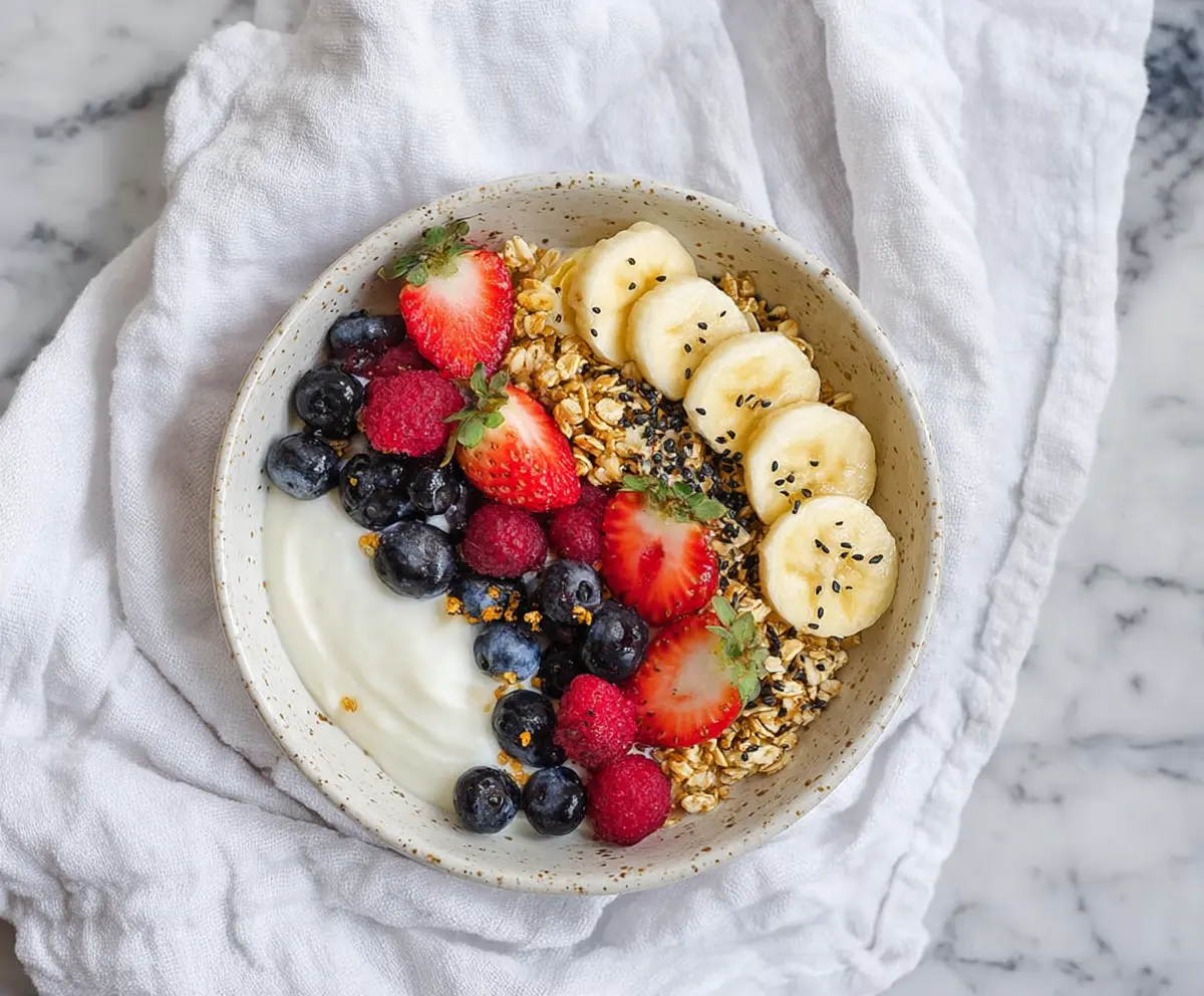 Healthy Greek Yogurt Protein Bowl topped with fresh berries and nuts for a nutritious breakfast.