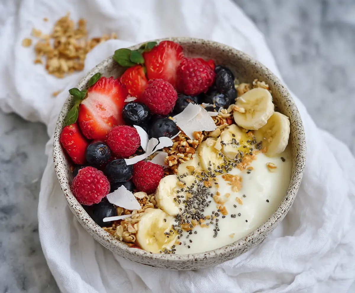 Healthy protein yogurt bowl topped with fresh berries and granola for a nutritious breakfast.
