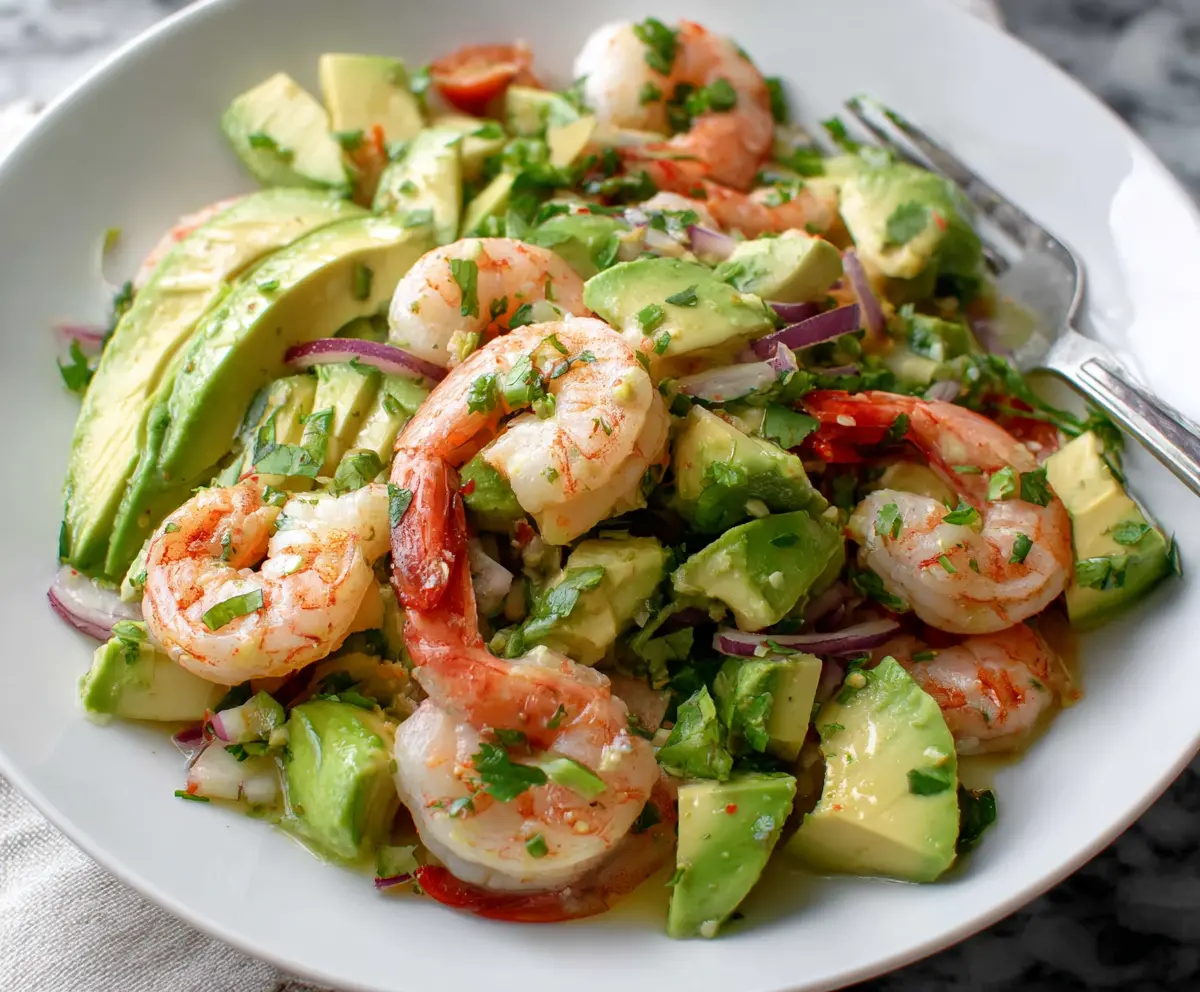 Fresh shrimp and ripe avocado salad served with lemon wedges