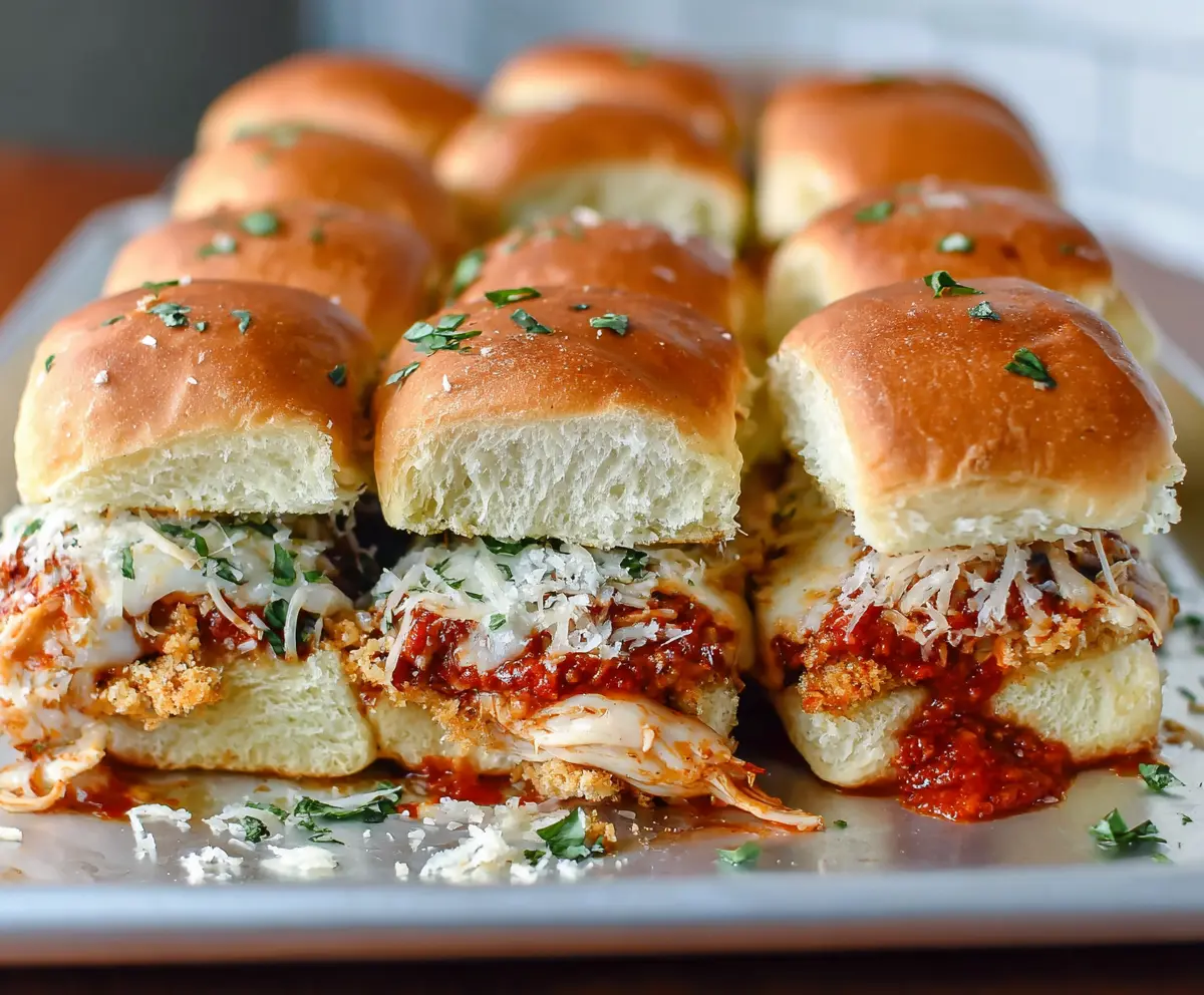 Delicious garlic chicken parmesan sliders with melted cheese and fresh herbs