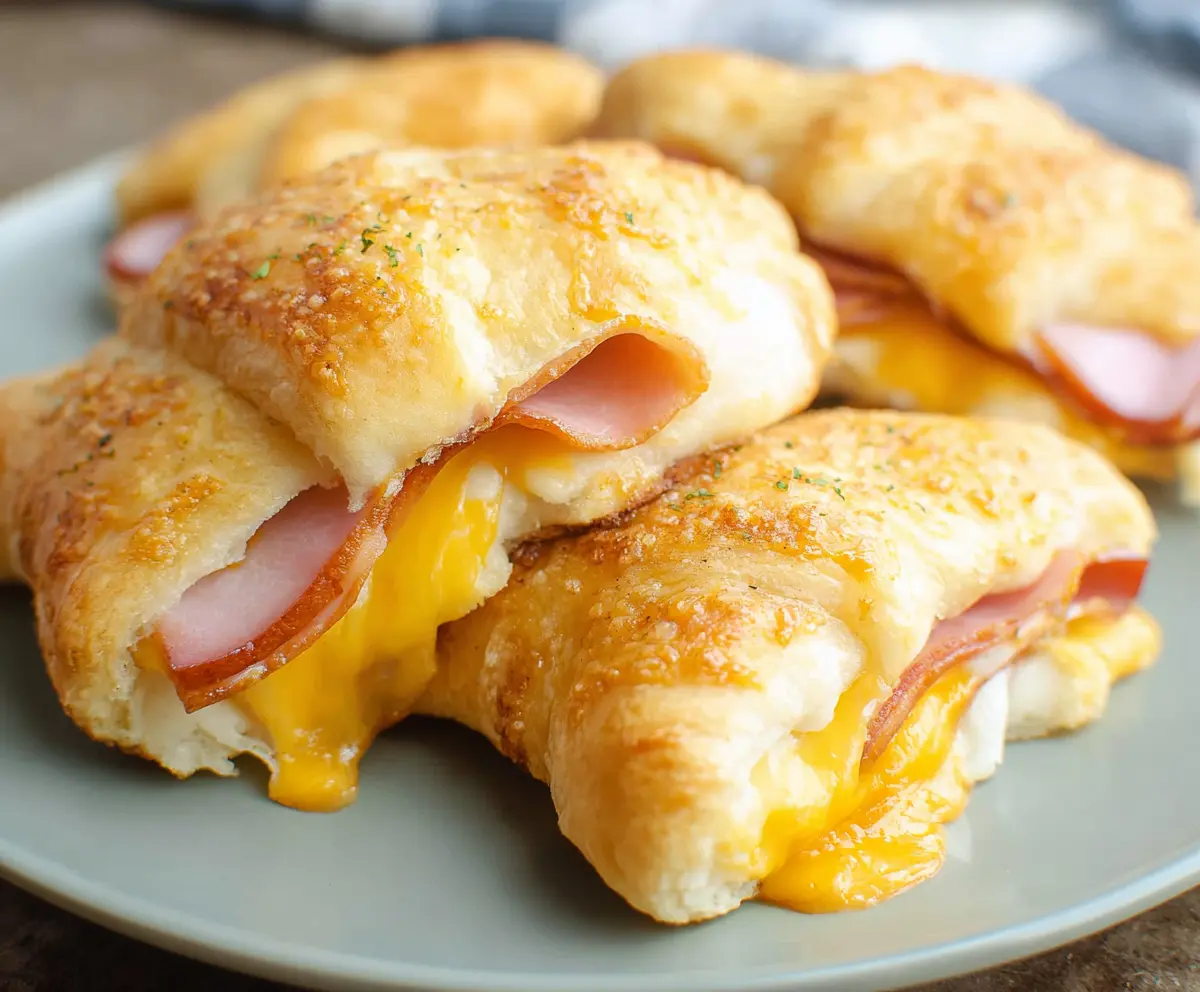 Delicious ham and cheese crescent rolls fresh out of the oven, perfect for breakfast or snacks.