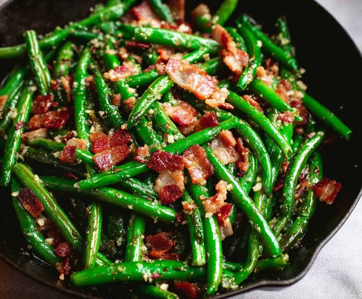 Delicious green beans with crispy bacon served as a savory side dish.