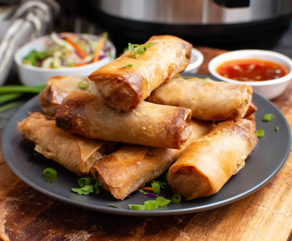 Crispy air fryer spring rolls filled with fresh vegetables served on a white plate